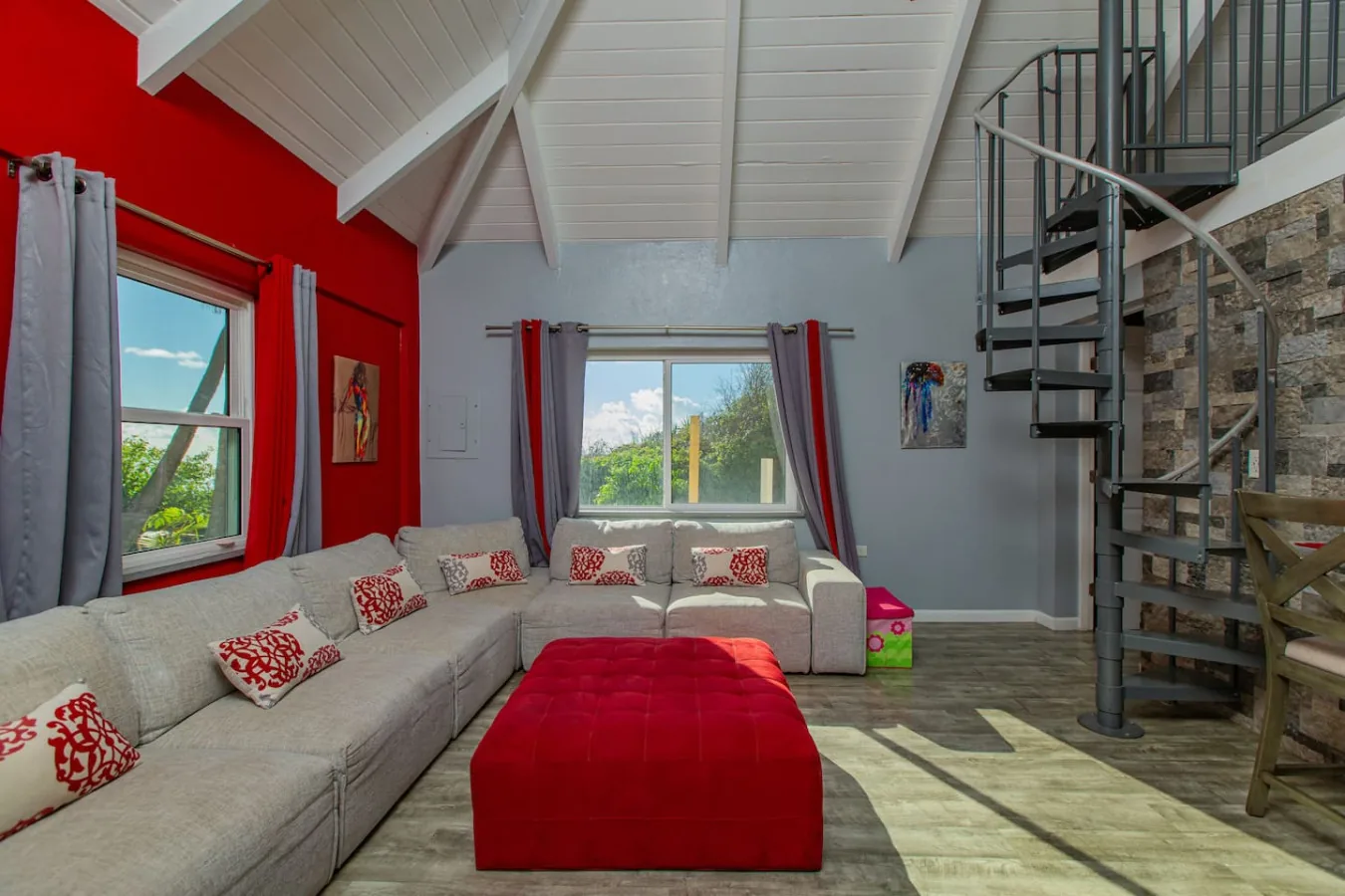 The cottage living room and the spiral stair up to the loft