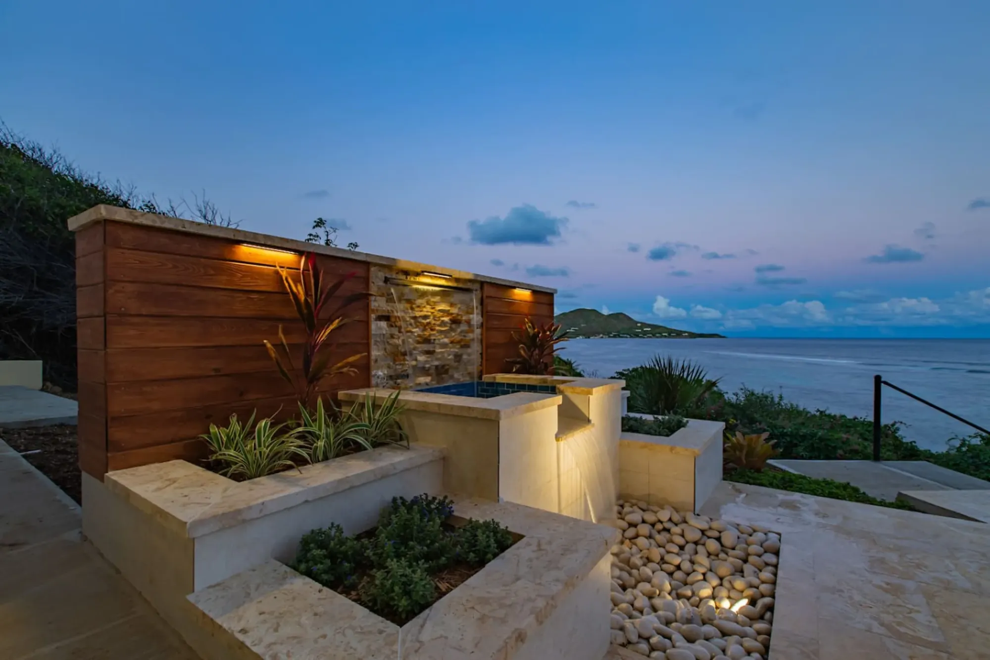 Fire-pit terrace above the water at dusk