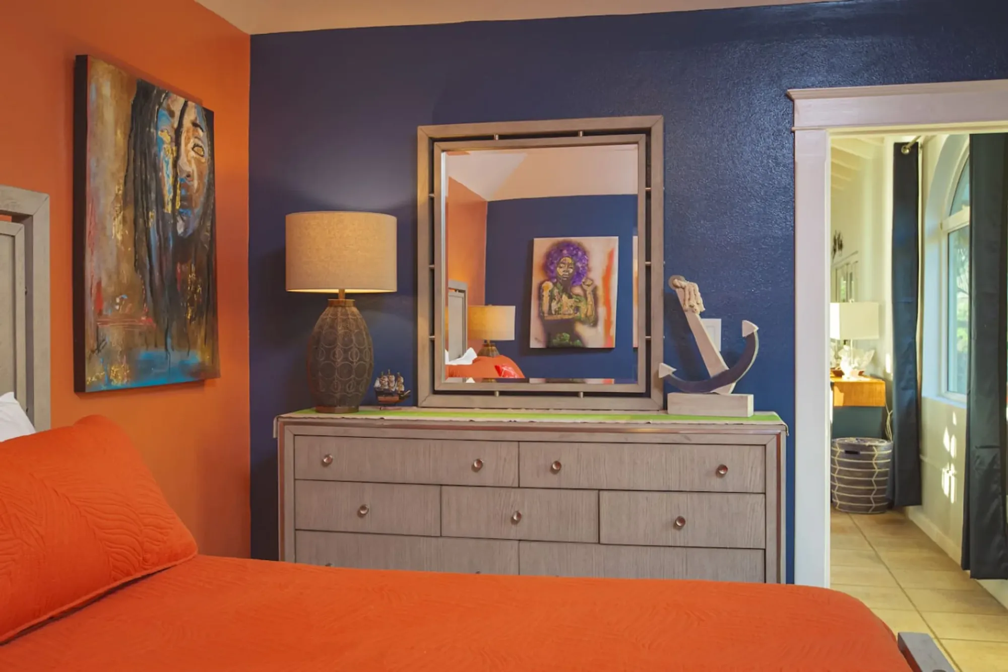 A bedroom with a navy accent wall