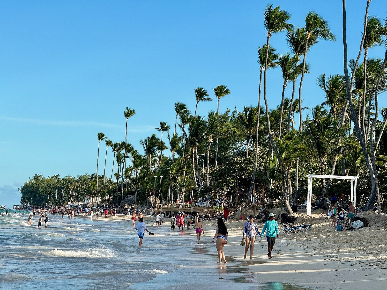 Swimmers and walkers on Bavaro beach at Punta Cana
