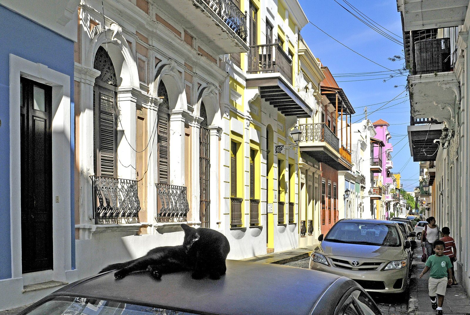 Pastel colonial houses with iron balconies on a street in Old San Juan, Puerto Rico