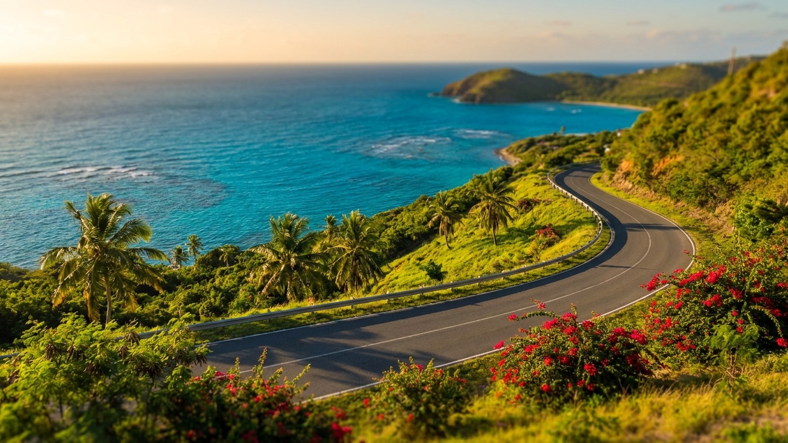 A scenic St Croix coast road curving along green hills above a turquoise Caribbean bay